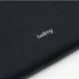 Black Bellroy Lite Laptop Sleeve for 16-inch laptops, shown with the sleeve open revealing a sleek interior.