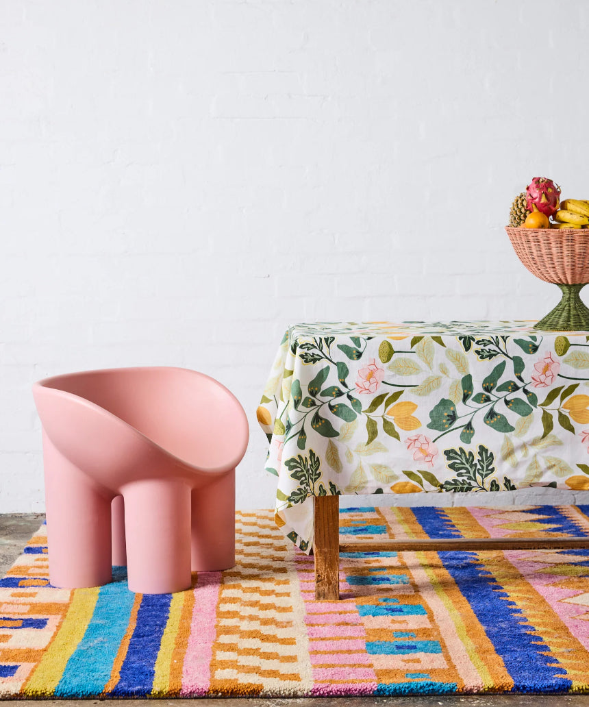 Kip & Co Wander rectangular tablecloth with colorful, patterned fabric draped over a dining table for a vibrant look.