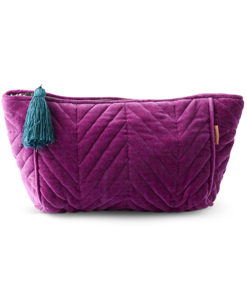 Kip & Co Wild Grape velvet toiletry bag with zipper closure, soft fabric, and compact design for accessories storage.