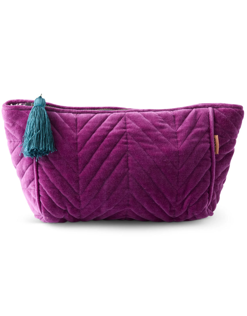 Kip & Co Wild Grape velvet toiletry bag with zipper closure, soft fabric, and compact design for accessories storage.