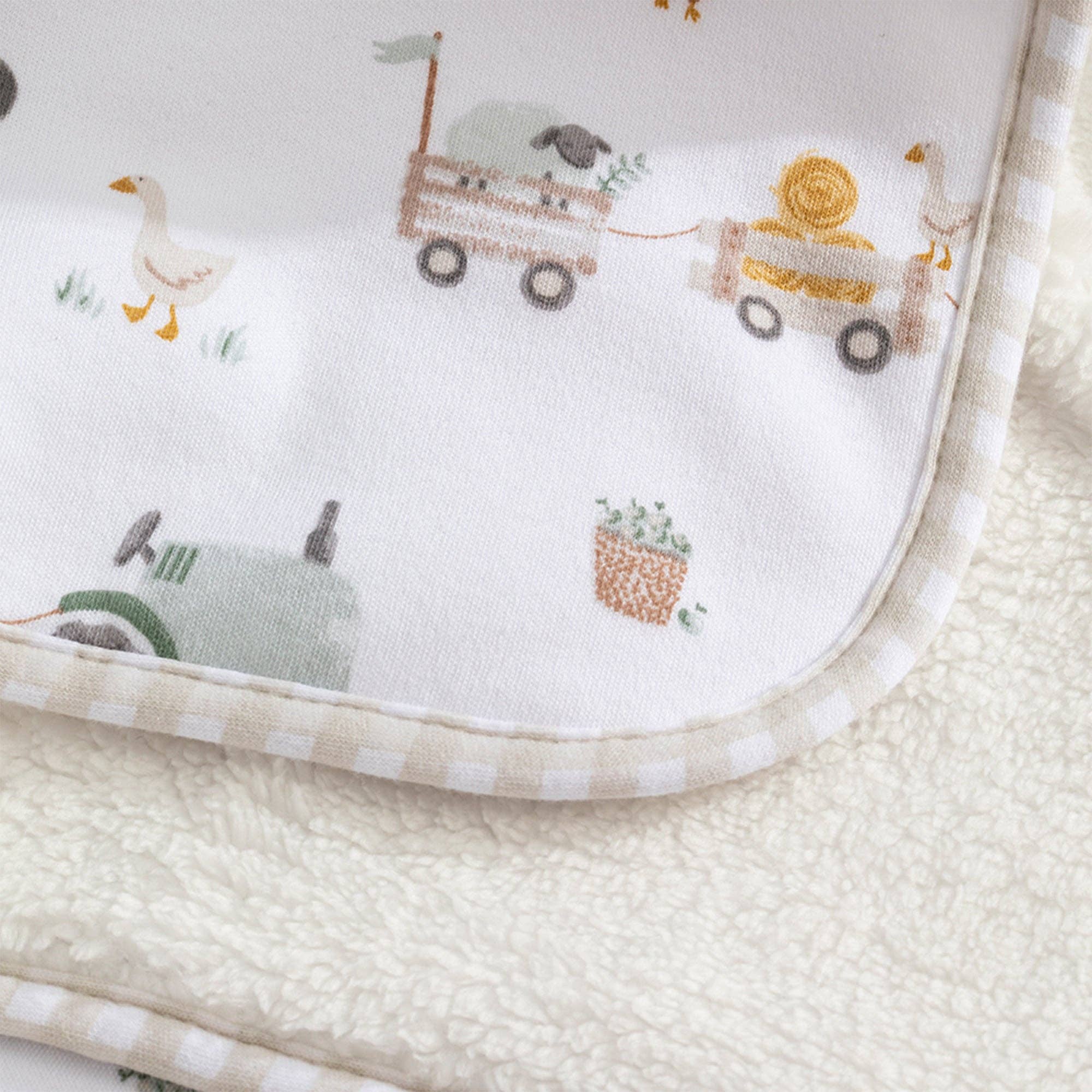 Living Textiles Jersey Sherpa Blanket featuring a tractor ride design, soft, cozy fabric ideal for comfort and warmth.