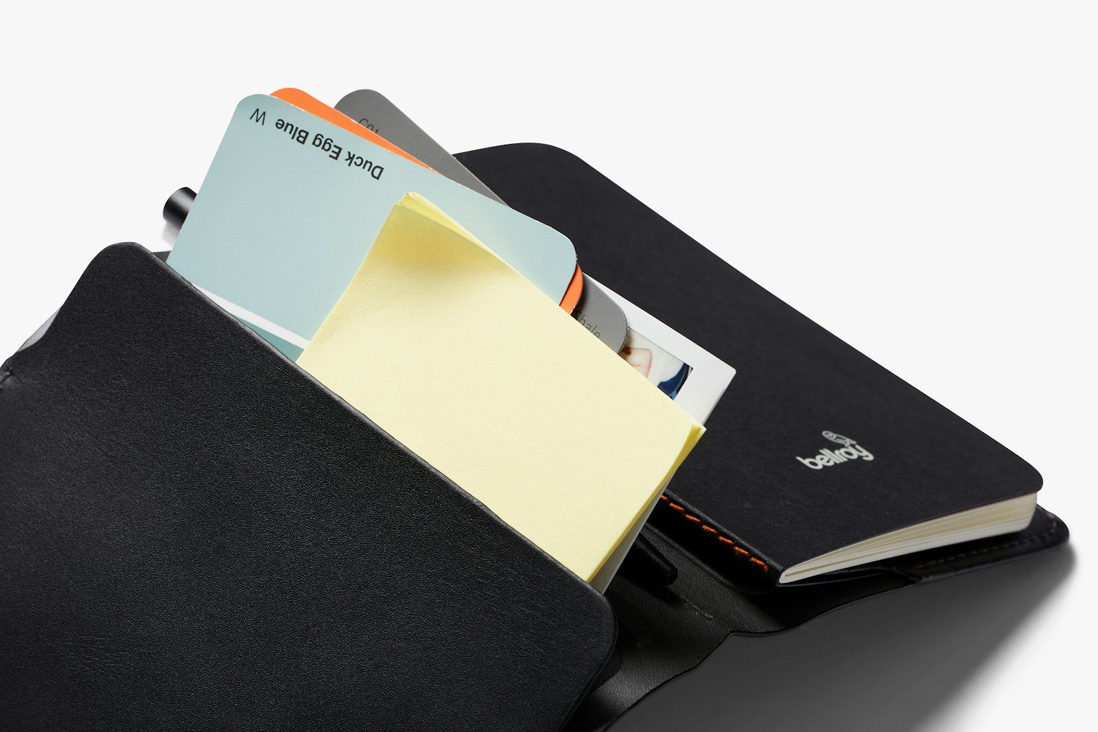 Bellroy black notebook cover showing sleek leather exterior with subtle stitching and compact design for easy carrying.