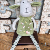 Amaranta Designs Daisy Lamb sculpture featuring a detailed white ceramic lamb with floral accents and intricate craftsmanship.