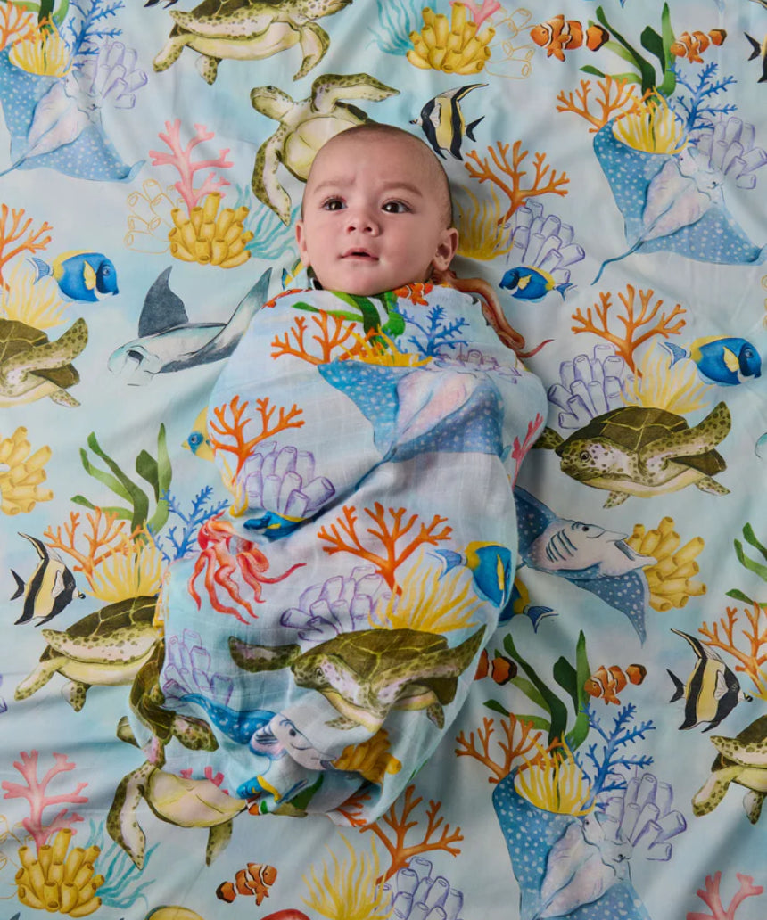 Kip & Co Reef Life bamboo swaddle with vibrant, tropical sea and coral print on soft fabric for baby comfort and style.
