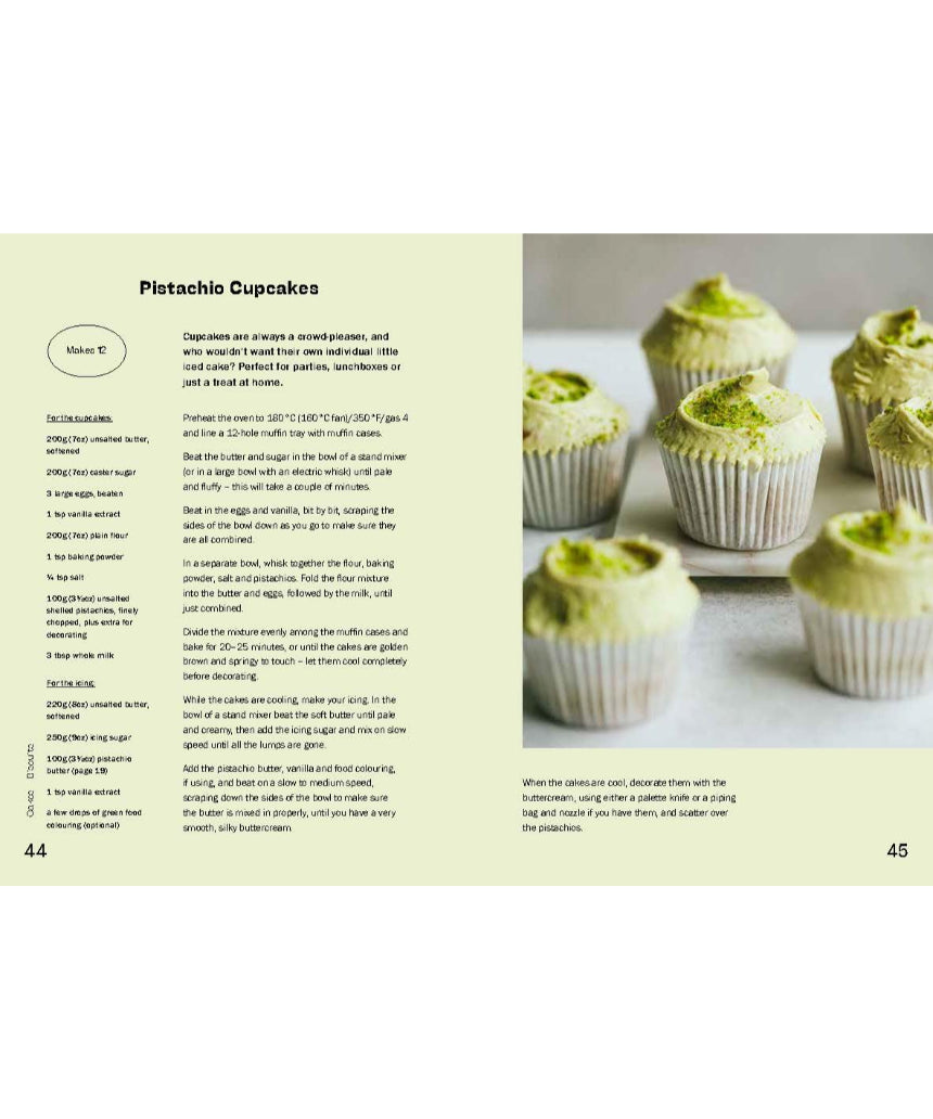 Open baking book by Brumby Sunstate featuring pistachio recipes and detailed baking tips on a wooden table.