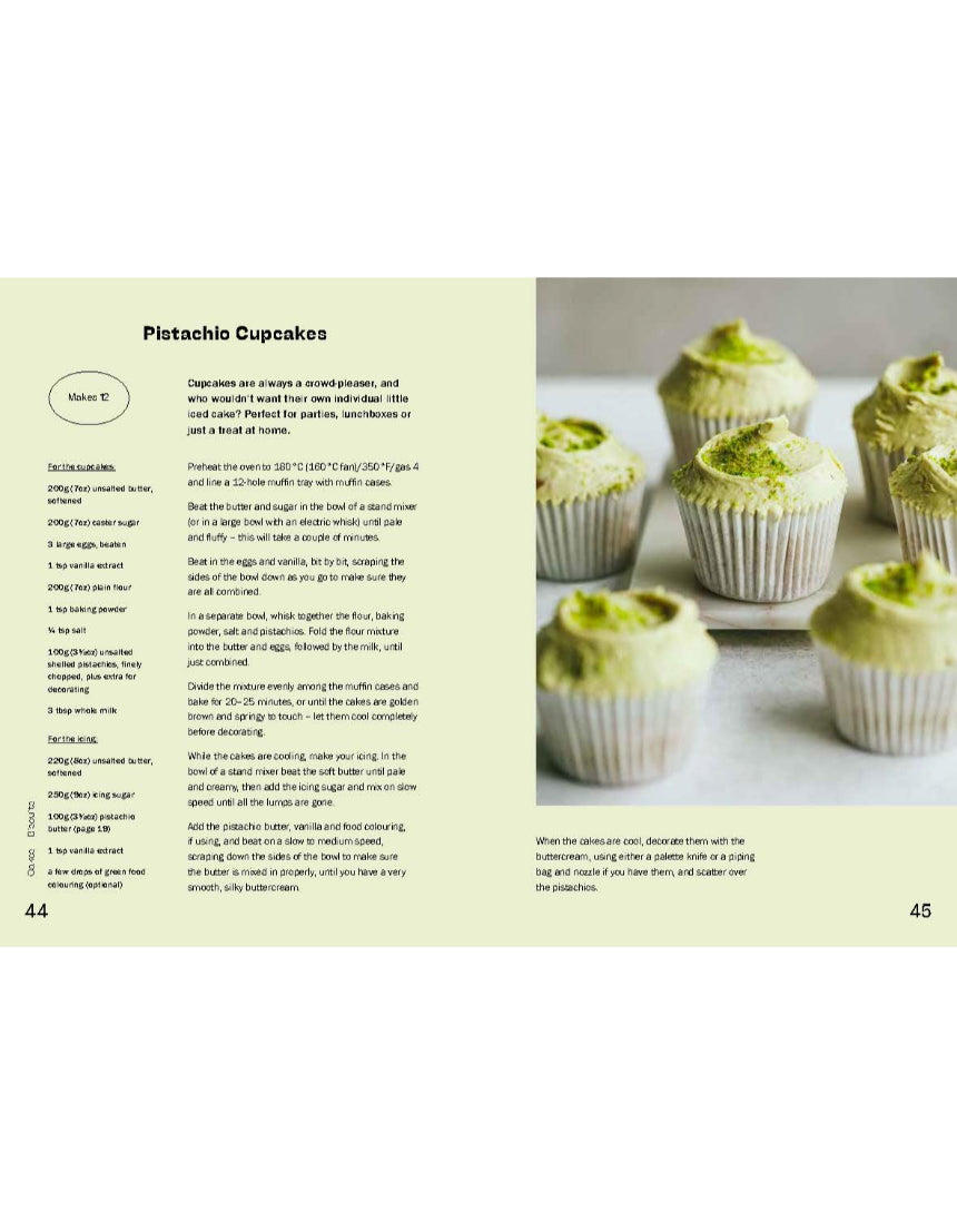Open baking book by Brumby Sunstate featuring pistachio recipes and detailed baking tips on a wooden table.