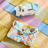 Kip & Co Cheer Up baby change mat with colorful, playful design on soft cushioned surface for comfortable diaper changes