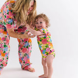 Kip & Co baby clothing Follow the Sun short sleeve frill romper with colorful floral print and ruffled details.
