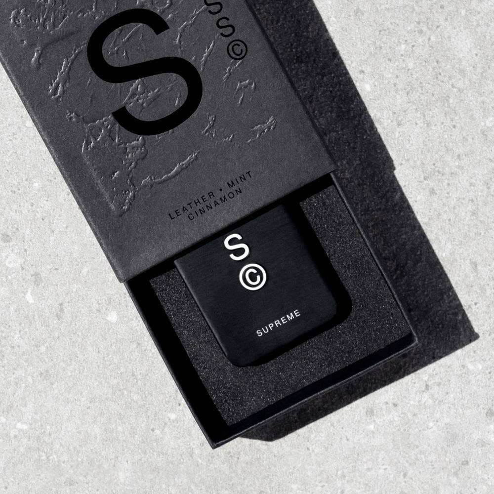 Solid State Supreme Solid Cologne in a sleek black container, showcasing the compact and stylish design of the men's fragrance product.