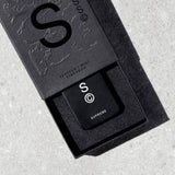 Solid State Supreme Solid Cologne in a sleek black container, showcasing the compact and stylish design of the men's fragrance product.