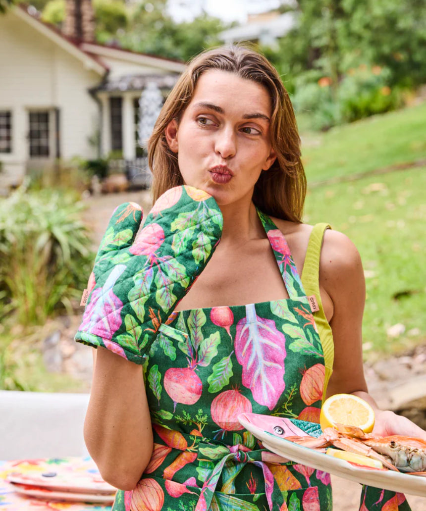 Kip & Co veggie soup apron with colorful vegetable print, cotton fabric, ties at the neck and waist, perfect for cooking and kitchen use.