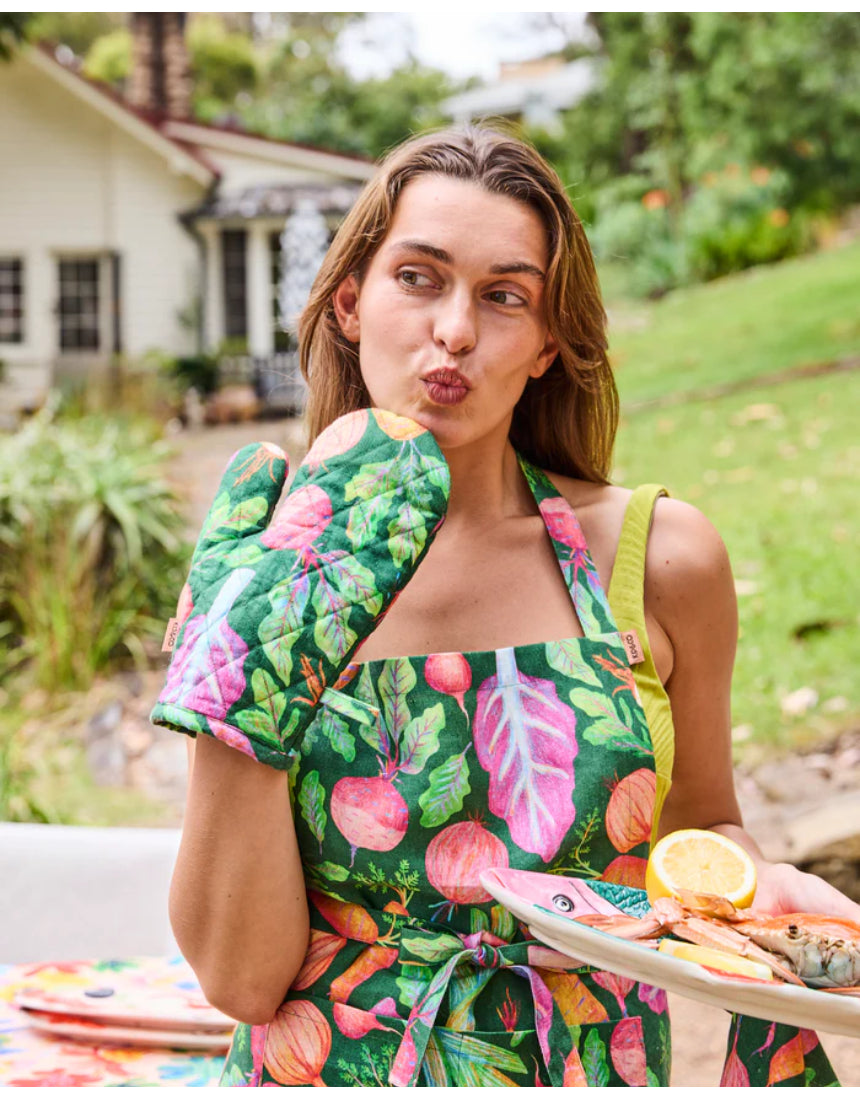 Kip & Co veggie soup apron with colorful vegetable print, cotton fabric, ties at the neck and waist, perfect for cooking and kitchen use.