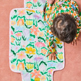 Kip & Co Popping Flowers green baby change mat with floral print, padded surface, and secure straps for comfortable changing.
