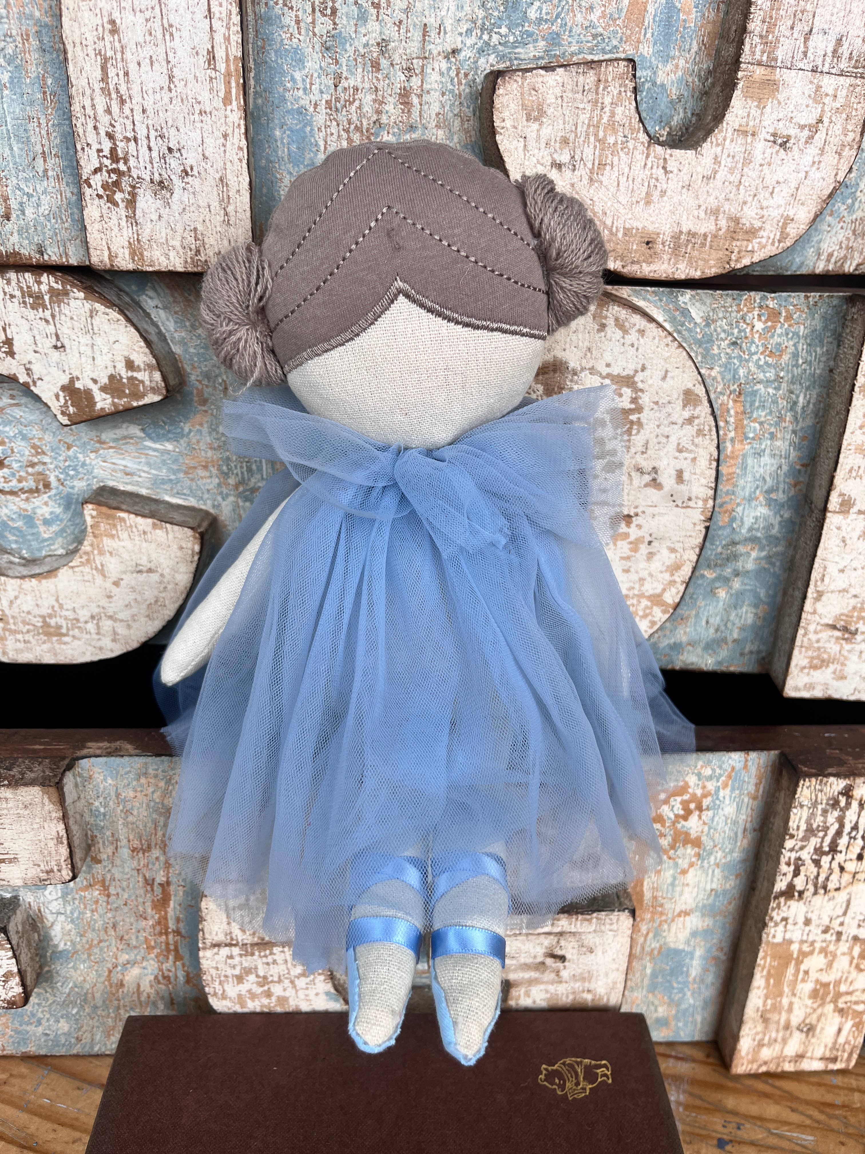 Amaranta Designs ballerina doll with pink tutu, long brown hair, and delicate facial features, dressed in a graceful ballet pose.
