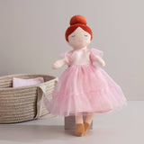 Living Textiles Princess Doll Zara with a colorful dress, blonde hair, and a crown, sitting with a cheerful expression.