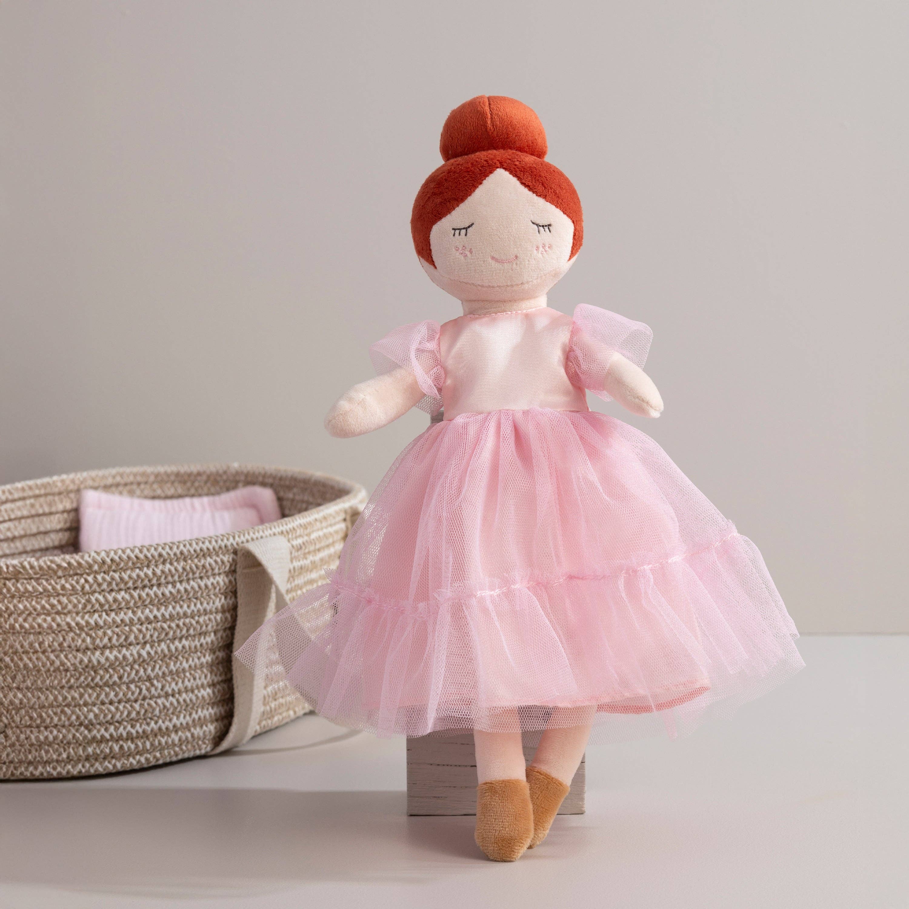 Living Textiles Princess Doll Zara with a colorful dress, blonde hair, and a crown, sitting with a cheerful expression.