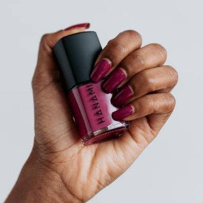 Hanami Cosmetics Doria nail polish bottle with pinkish-purple polish and sleek design, showcasing the Hanami nail polish product.