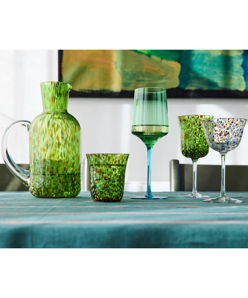 Kip & Co Garden Soiree Speckle Water Jug used as a vase, featuring a speckled design and a rounded shape, on a wooden surface.