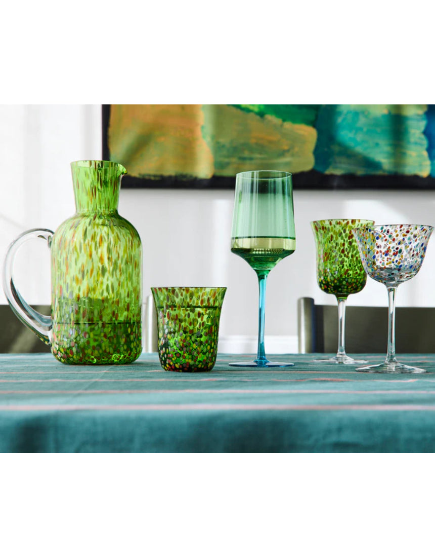 Kip & Co Garden Soiree Speckle Water Jug used as a vase, featuring a speckled design and a rounded shape, on a wooden surface.