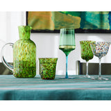 Kip & Co Garden Soiree Speckle Water Jug used as a vase, featuring a speckled design and a rounded shape, on a wooden surface.
