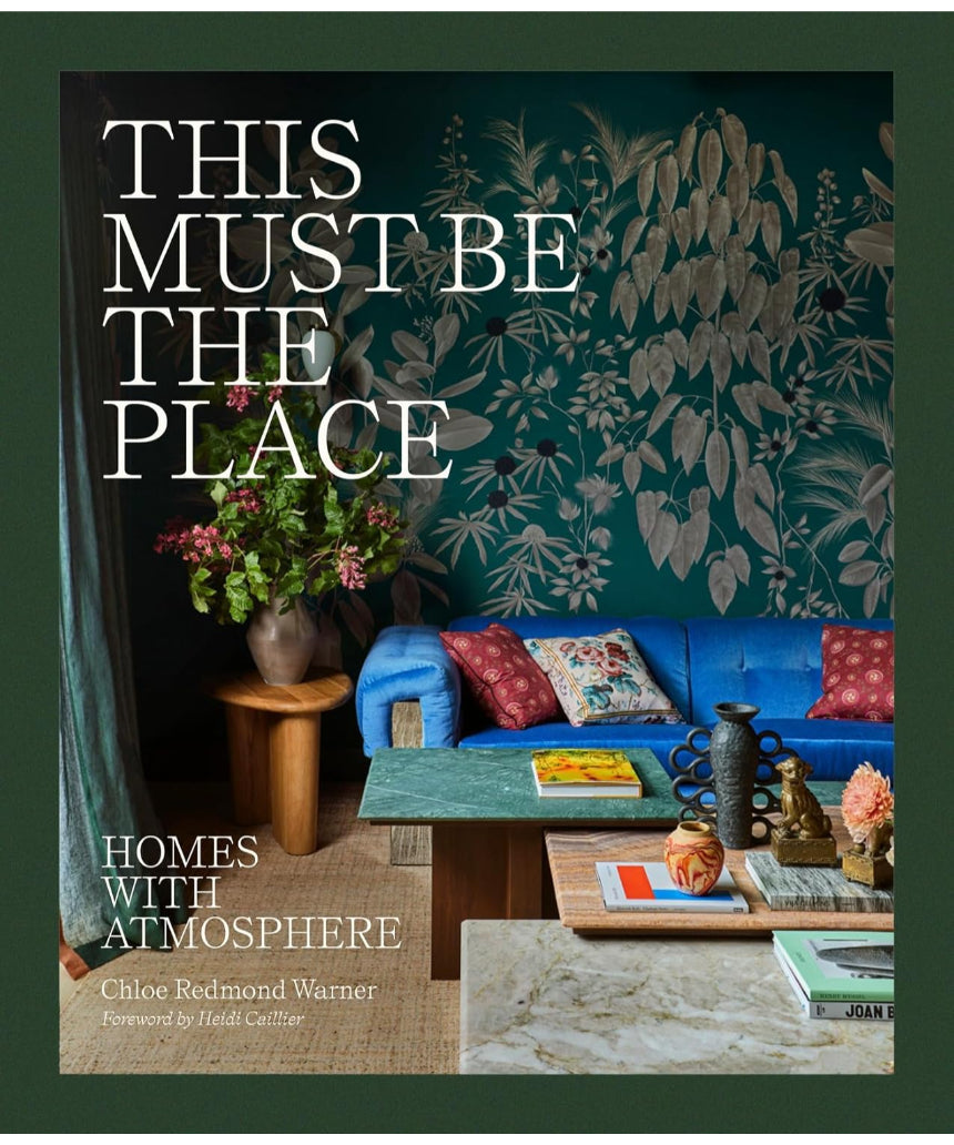 Cover image of "This Must Be The Place – Homes With Atmosphere" book by Brumby Sunstate, featuring a cozy home scene.