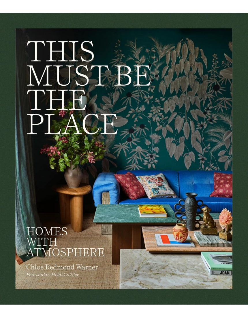 Cover image of "This Must Be The Place – Homes With Atmosphere" book by Brumby Sunstate, featuring a cozy home scene.