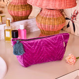 Kip & Co Wild Grape velvet toiletry bag with a soft, plush texture and vibrant purple and pink floral pattern.