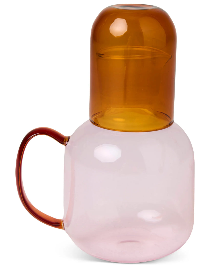 Kip & Co marshmallow and marmalade glass carafe with matching glass set on a wooden surface.