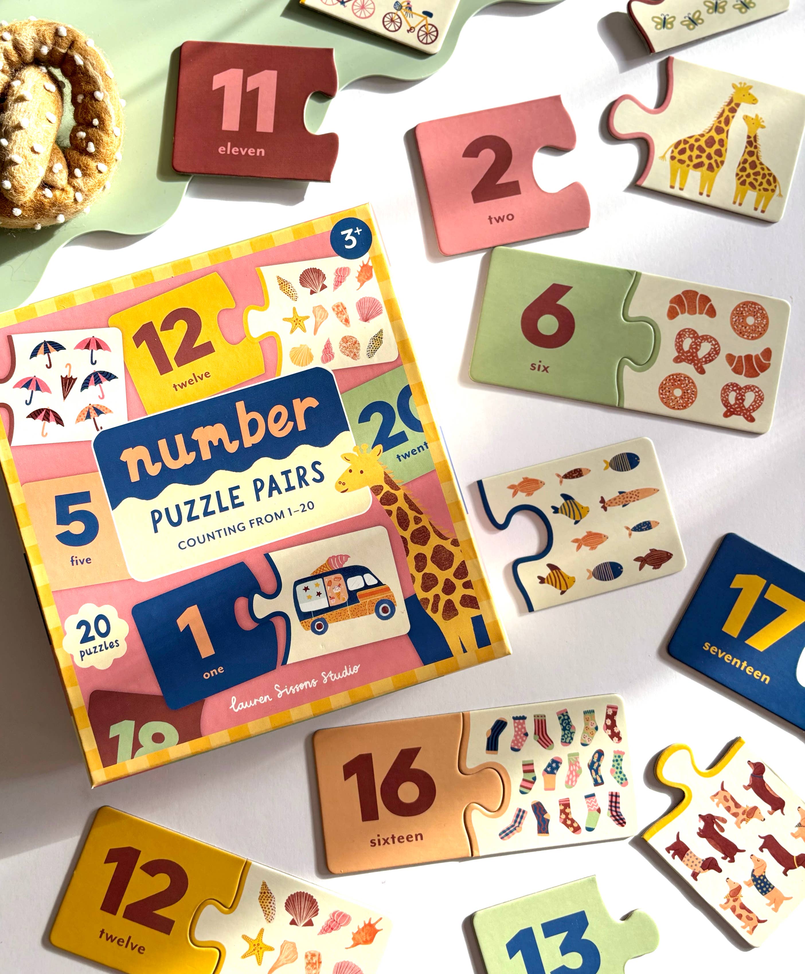 Lauren Sissons Studio Number Puzzle Pairs, colorful educational toy with numbered wooden pieces for children.