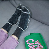 Black Glitter Lurex Socks by Klue, stylish socks with shimmering lurex fabric and a comfortable fit.