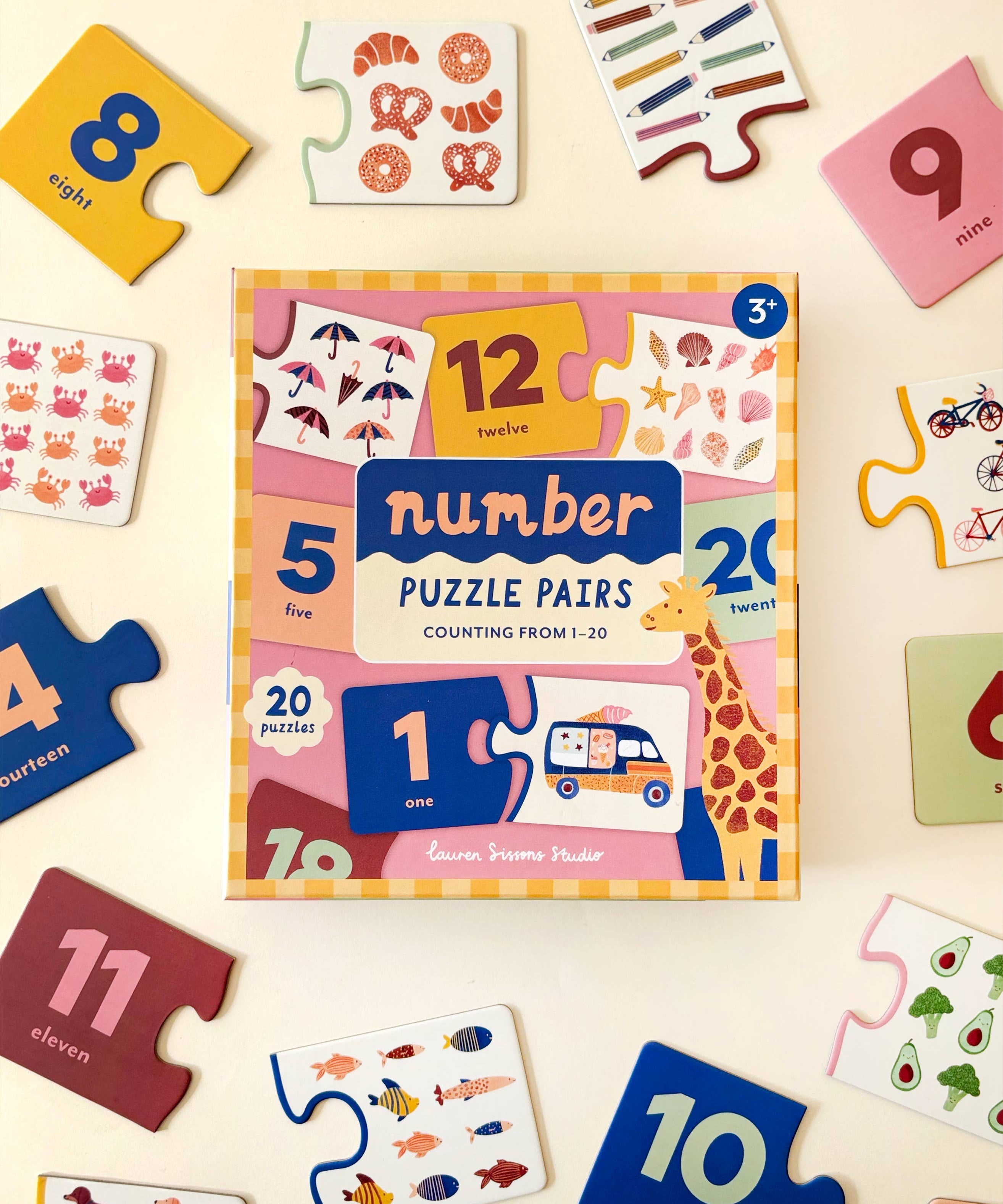 Lauren Sissons Studio Number Puzzle Pairs featuring colorful wooden number blocks arranged in matching pairs on a white background.