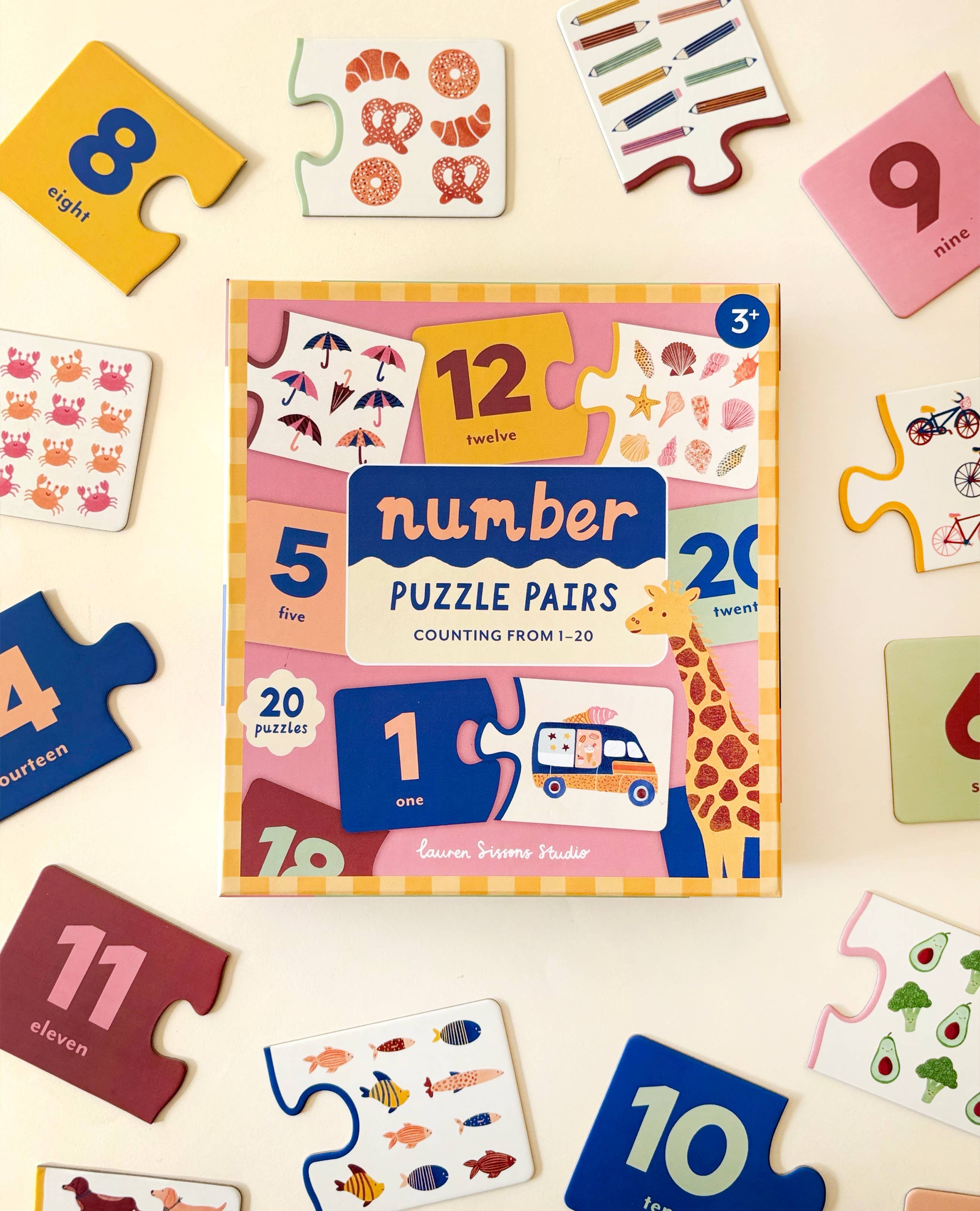 Lauren Sissons Studio Number Puzzle Pairs featuring colorful wooden number blocks arranged in matching pairs on a white background.