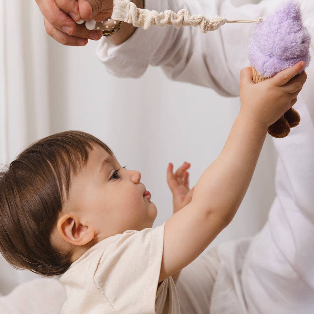 Living Textiles stroller toys featuring plush ice cream and cupcake designs for baby entertainment and sensory development.