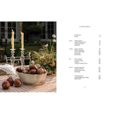 Open book titled "Around the Table Tables and Traditions for Gathering" by Brumby Sunstate, featuring reading pages and cover.