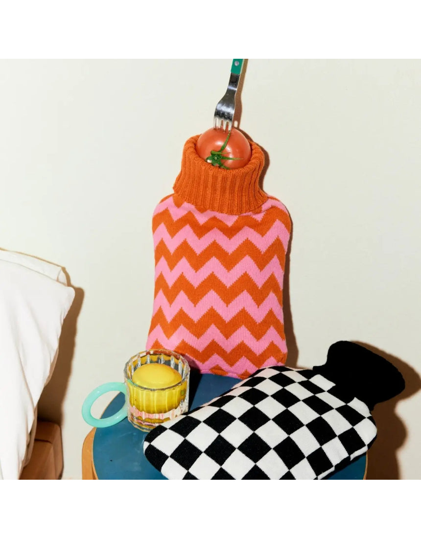 Casa Rolio hot water bottle with orange cover, tangerine color, soft fabric cover, and a flexible rubber bottle for warmth.