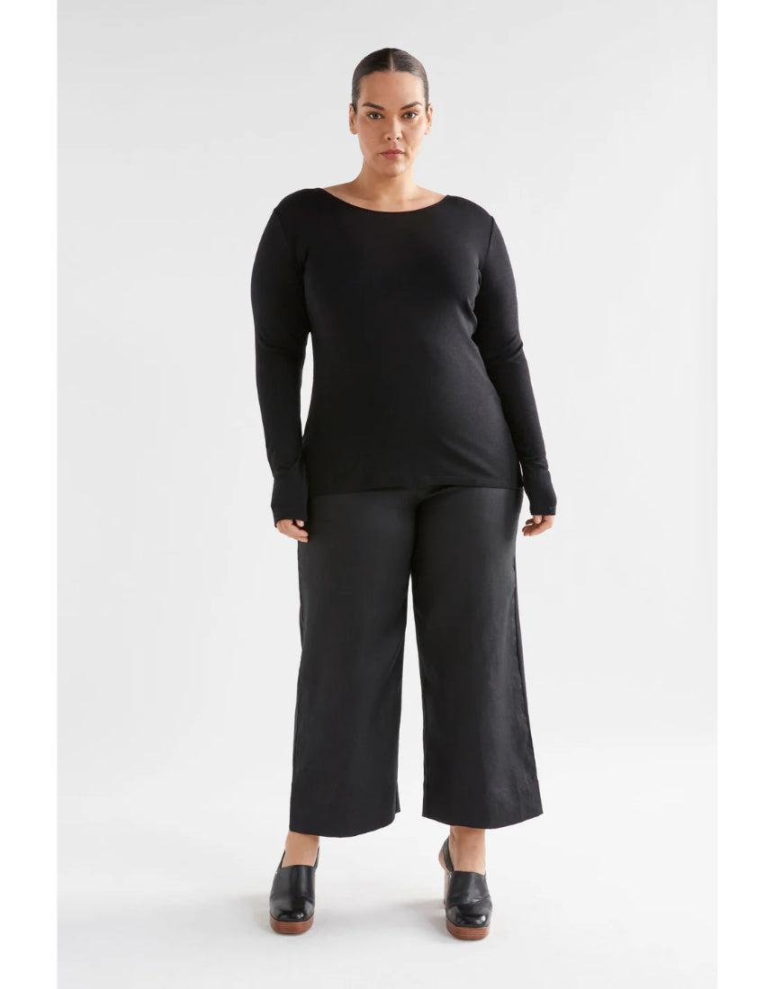 Black Elk Merino Long Sleeve Top, a warm and soft wool clothing item, shown on a model highlighting its fit and fabric texture.