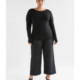Black Elk Merino Long Sleeve Top, a warm and soft wool clothing item, shown on a model highlighting its fit and fabric texture.
