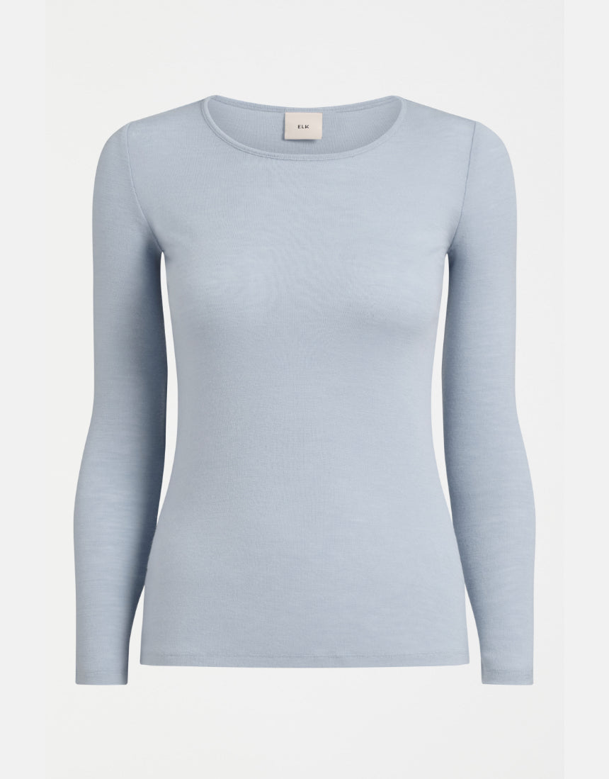 Elk Merino Long Sleeve Top in Pearl Blue, showcasing a soft, fitted wool shirt with long sleeves and a high neckline.
