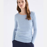 Elk Merino long sleeve top in pearl blue, lightweight, soft wool clothing with a fitted design, displayed on a hanger.