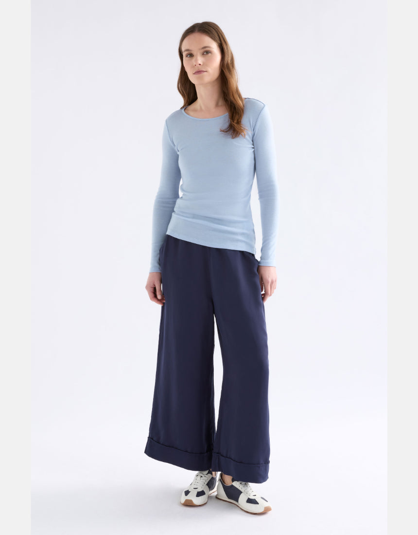 Elk Merino long sleeve top in pearl blue, showcasing a comfortable, fitted design made from soft merino wool fabric.