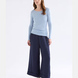 Elk Merino long sleeve top in pearl blue, showcasing a comfortable, fitted design made from soft merino wool fabric.