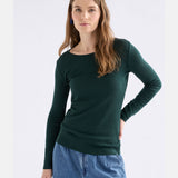 Elk Merino long sleeve top in dark pine color, lightweight and soft, shown on a hanger with a close-up of the fabric texture.