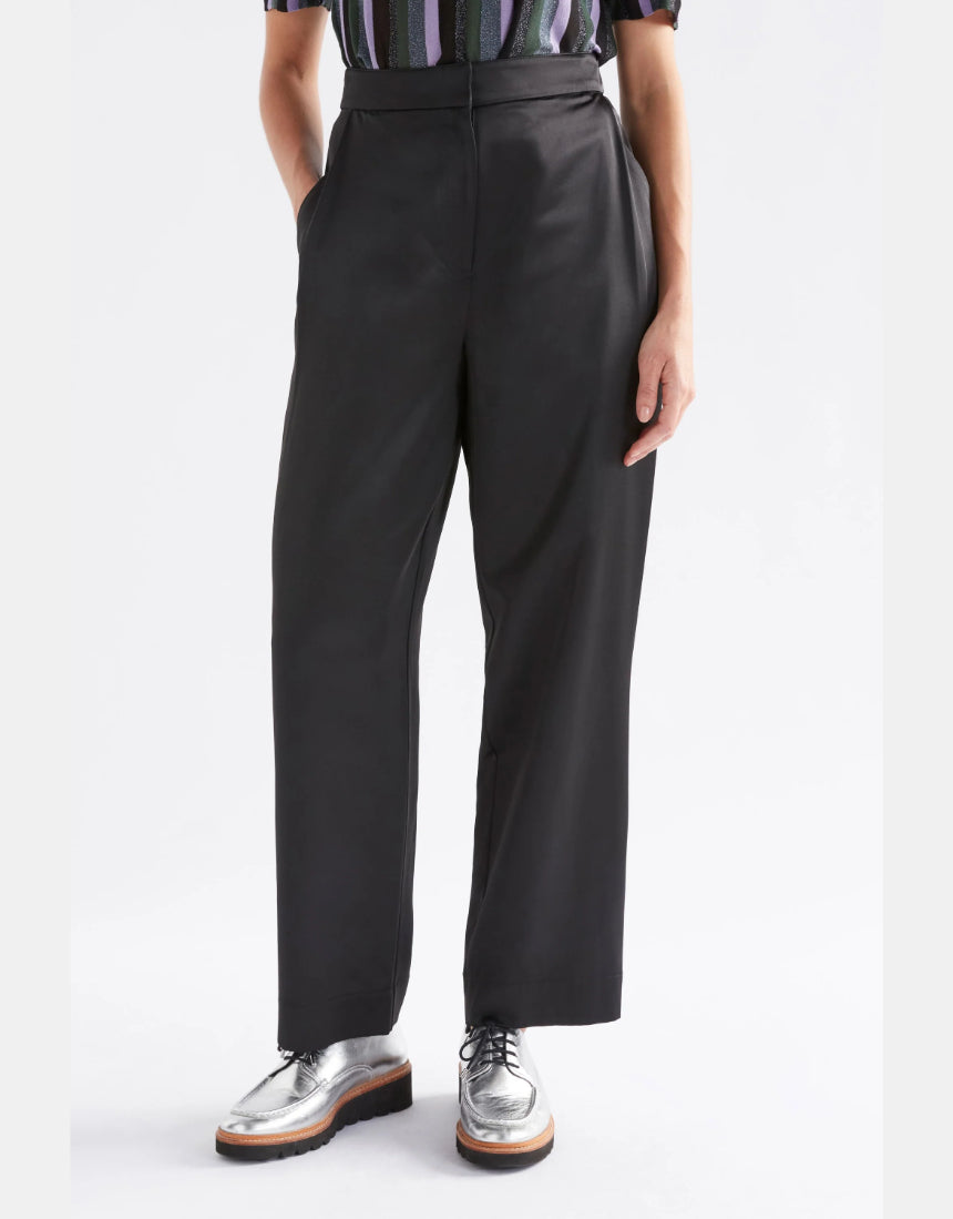 Black Elk Este Pant showing a slim fit design with waistband and front pockets, made from comfortable fabric.