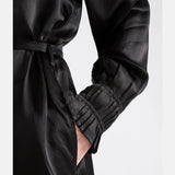 Elk Karta Dress in black, lightweight clothing with a relaxed fit, displayed on a model, showcasing casual fashion style.