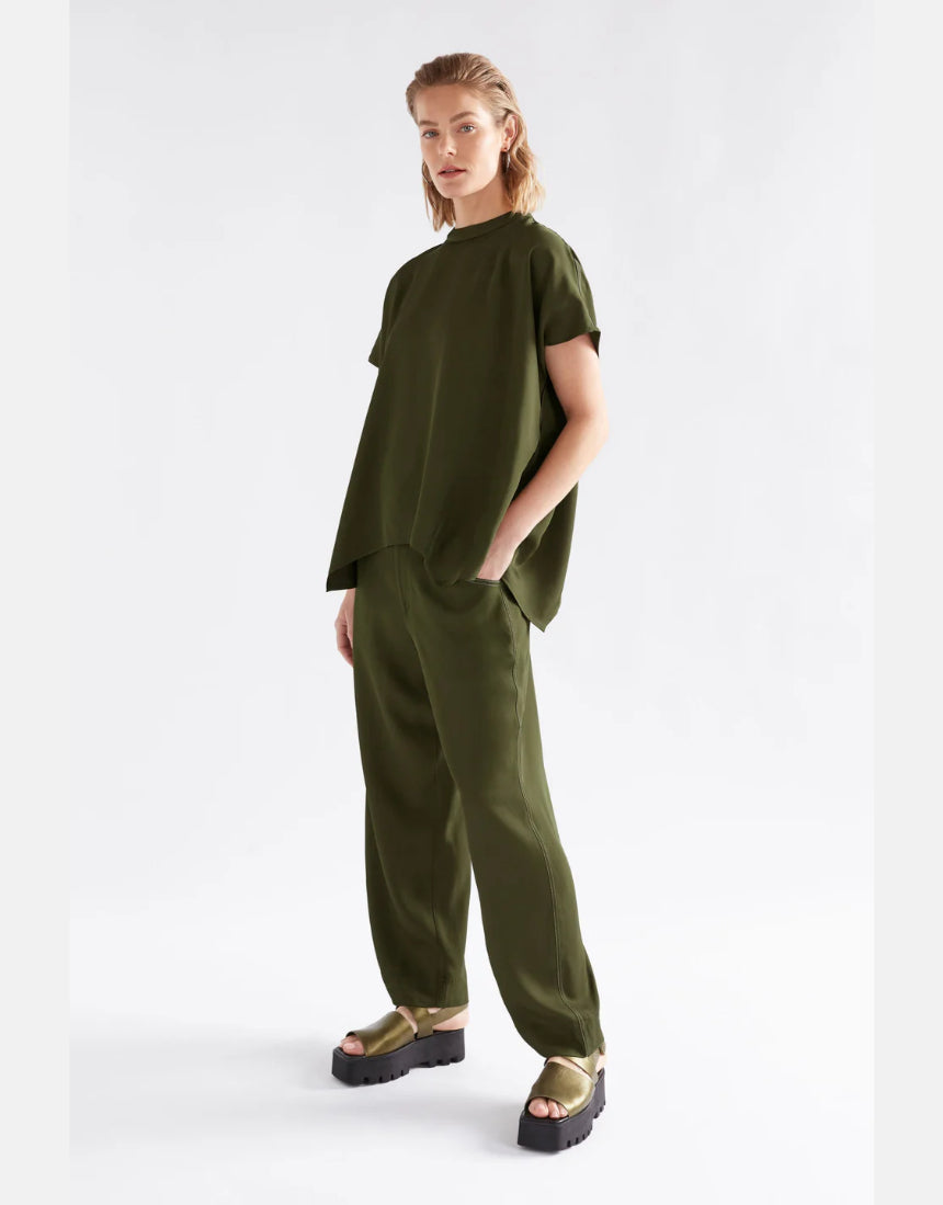 Elk Hullu Top in bright olive, a stylish women's clothing top made from comfortable fabric, featuring a relaxed fit and long sleeves.