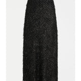 Black Elk Ilta Skirt displayed on a hanger, featuring a stylish, flowy design perfect for casual or dressy occasions.