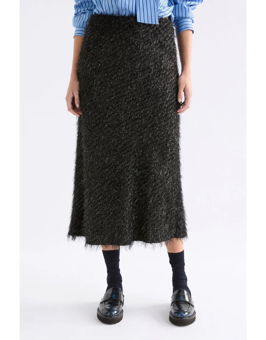 Black Elk Ilta Skirt displayed on a hanger, showcasing its sleek design and fabric details. Perfect for stylish, casual outfits.