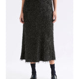 Black Elk Ilta Skirt displayed on a hanger, showcasing its sleek design and fabric details. Perfect for stylish, casual outfits.