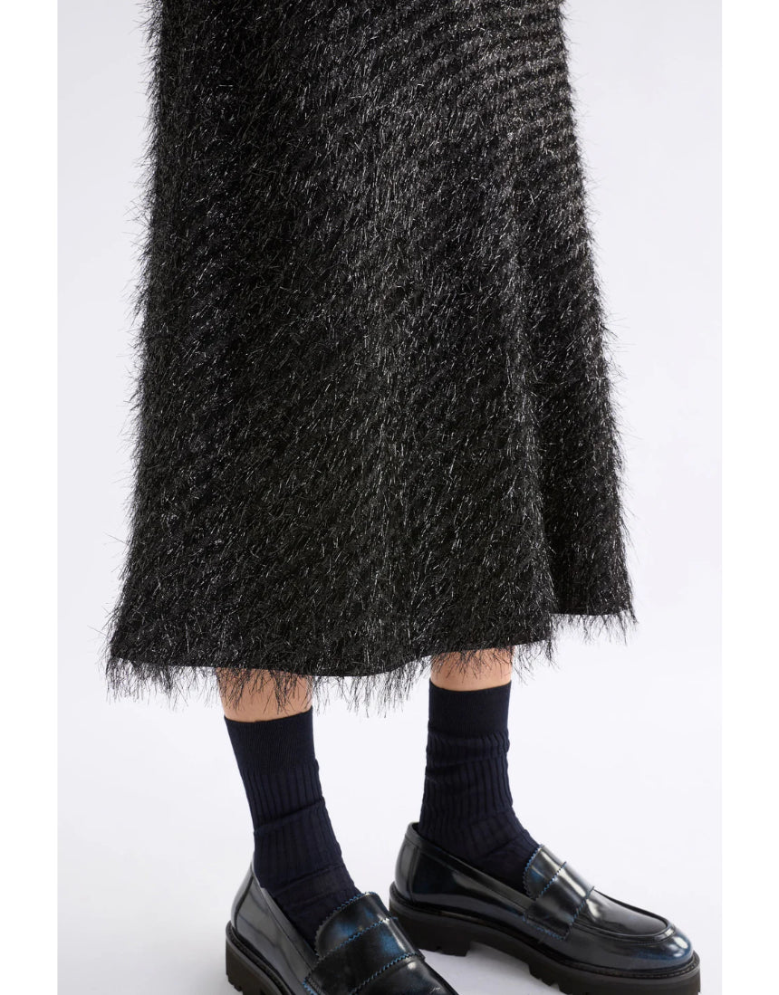 Black Elk Ilta Skirt with a flowing design, showcased on a neutral background, emphasizing style and fabric texture.