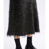 Black Elk Ilta Skirt with a flowing design, showcased on a neutral background, emphasizing style and fabric texture.